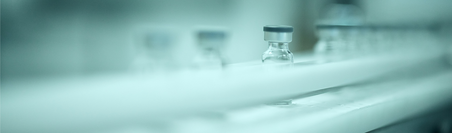 Close-up of a pharmaceutical vial in a laboratory setting